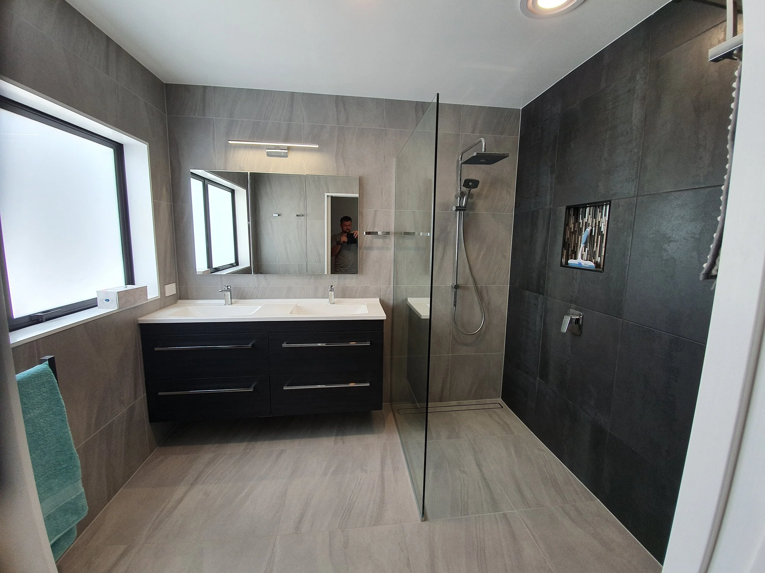 New bathroom with wall-hung vanity and walk-in tiled shower
