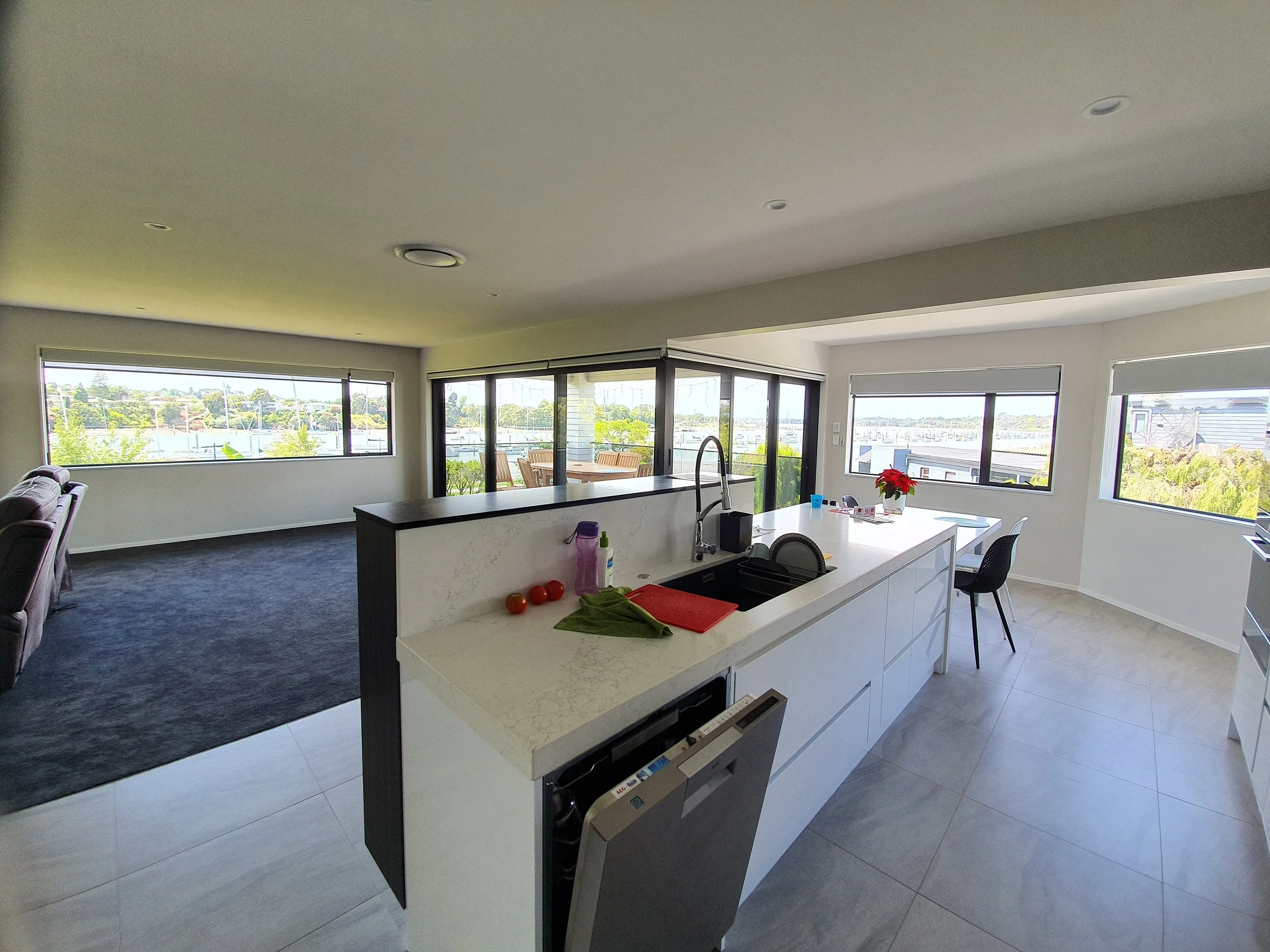 Kitchen with stone benchtop island and harbour views