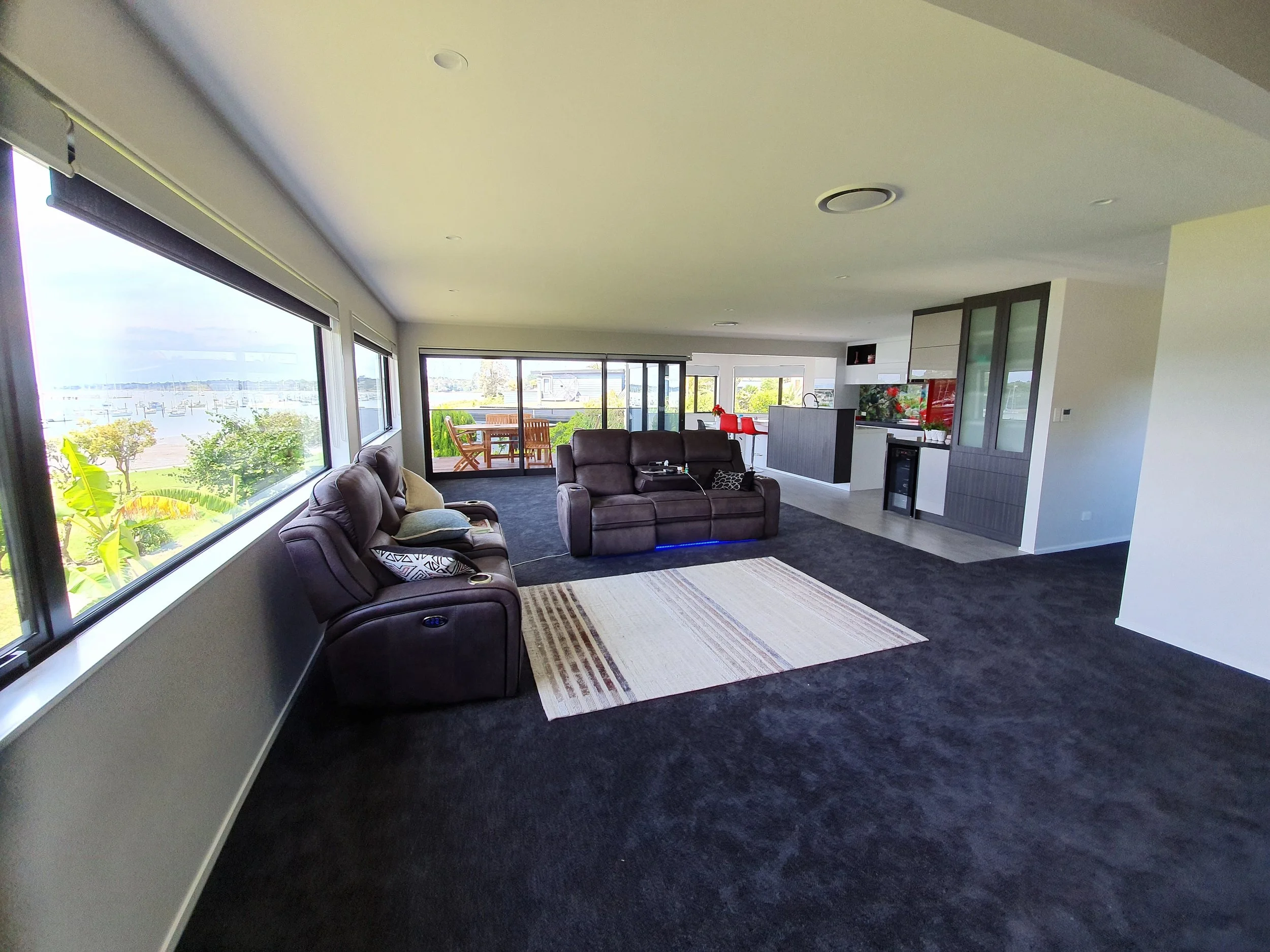 Living room with recliner seating and panoramic water views